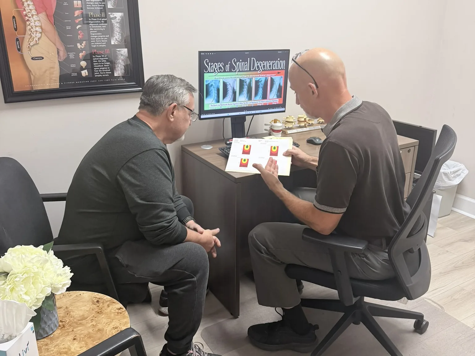 Dr. Jon Scott reviewing spinal health results with a patient