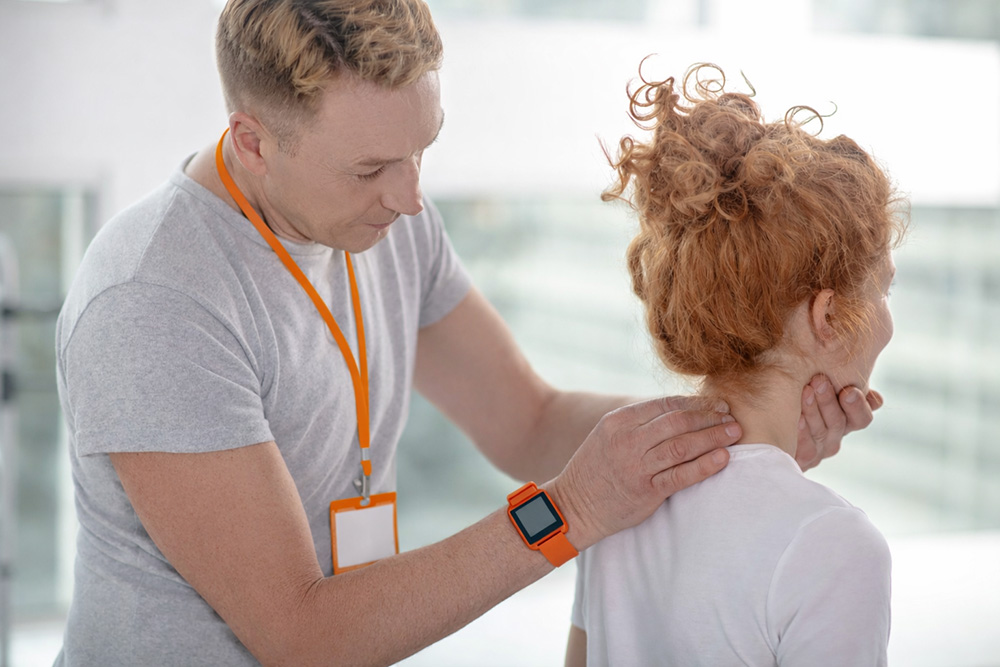 Expert chiropractor in Knoxville performing a neck exam on a patient to provide effective neck pain relief in Knoxville TN.